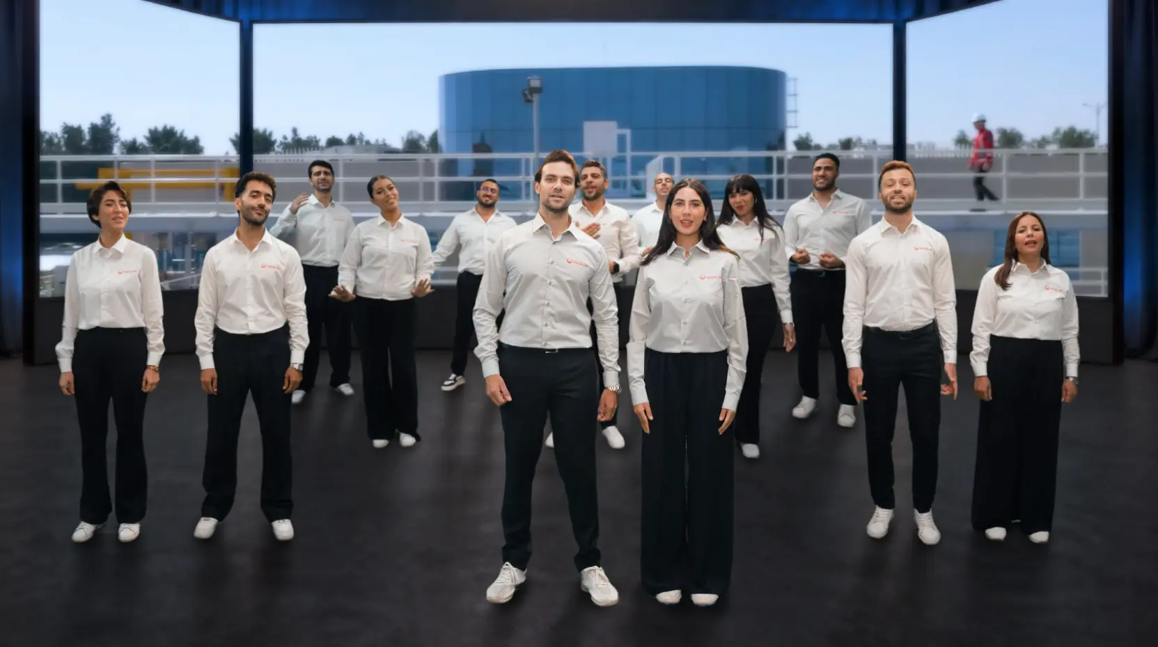 Veolia employees performing together inside a cinematic five-screen virtual stage